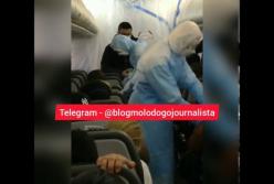 Люди в масках и спецкостюмах: появилось видео из салона самолета с эвакуированными из Китая украинцами (видео)